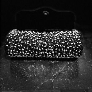 Black beaded cocktail purse.Measures 7.25”W/4”L/3.3/4 deep, 22 inch strap